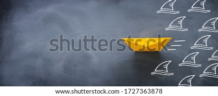 concept banner of avoiding crisis. paper boat escaping sharks idea