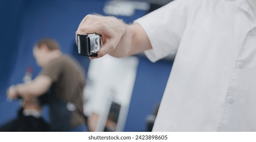 Concept banner Barbershop for man. Closeup master barber hairdresser does hairstyle with hair clipper and comb. - Powered by Shutterstock