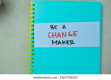 Concept of Be a Change Maker write on sticky notes isolated on Wooden Table.