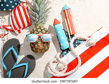 concept of beach party in honor of american independence day 4th july. pineapple with glasses stylized as an American flag on the sand on the beach - Powered by Shutterstock