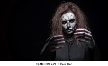 concept, beautiful makeup for halloween. Portrait of a young sexy girl with skull makeup. on a black background, face in the dark. close-up - Shutterstock ID 1466004167