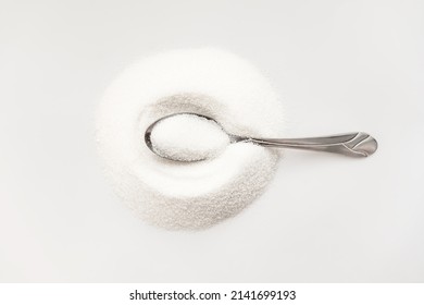 the concept of the benefits and harms of sugar, white on white. hyperglycemia, hypoglycemia. food,
Sugar on a white background on a metal spoon, metal spoon, top view, harm or benefit of white sugar, 