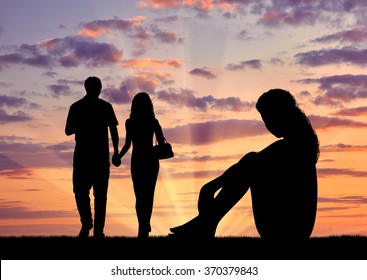 Concept Of Betrayal And Treason. Silhouette Of A Lonely Woman Looking At Loving Couple At Sunset