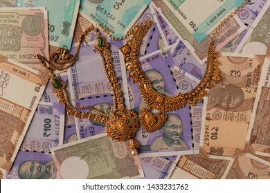 Concept Of Black Money, IT Raid, Confiscated Money And Gold Price In India Showing Indian Currency Notes With Jewelry.