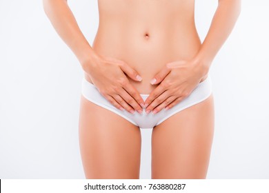 Concept of bodycare gynecology and woman's health. Cropped close up photo of woman's hand touching lower part of her abdomen, isolated on white background