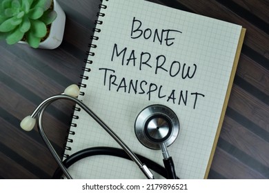 Concept of Bone Marrow Transplant write on a book with stethoscope isolated on Wooden Table.