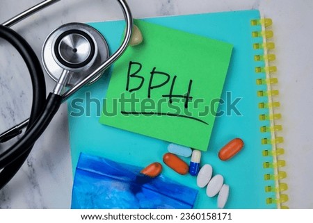 Concept of BPH write on sticky notes with stethoscope isolated on Wooden Table.