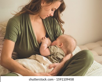 The concept of breastfeeding. Portrait of mom and breastfeeding baby.  - Shutterstock ID 1591109458