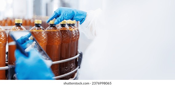 Concept brewery food industry banner. Factory worker with computer tablet inspecting production line with brown plastic bottles with beer. - Powered by Shutterstock