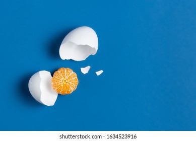 The concept of a broken egg, where instead of yolk peeled mandarin. Comic replacement of animal proteins with fruit. Funny veragatian breakfast. Substitution of objects based on shape and color.