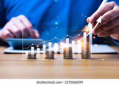 Concept of business growth in finance. businessperson calculate income and profit on investments and an increase in the indicators of positive growth, with virtual holographic chart graph. rich, coin