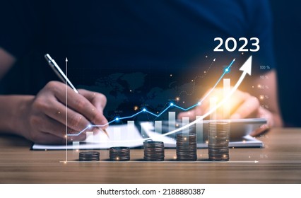 Concept Of Business And Industry Growth Trends In 2023. Businessman Planning Market Growth In 2023 On Desk With Virtual Hologram Chart. Economic Growth Strategy, Diversification, Market Penetration