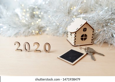 Concept For Business, New Year, Real Estate, Property, Rental, Hotel Business, Building. 2020 Happy New Year Wood Number, Wooden House And Keys On The Table