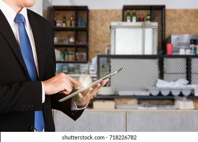 Concept of Business owner, Manager using tablet in restaurant for management