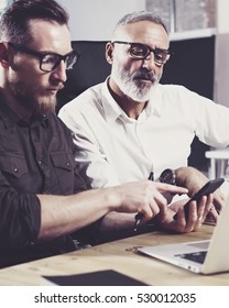 Concept Of Business People Meeting Process.Bearded Young Man Using Mobile Phone.Adult Colleague Working Together With Partner.Vertical, Blurred Background