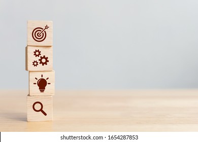Concept of business strategy and action plan. Wood cube block stacking with icon