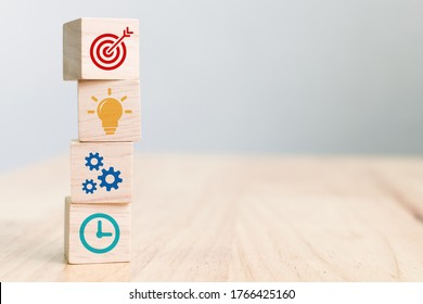 Concept of business strategy and action plan. Wood cube block stacking with icon - Shutterstock ID 1766425160
