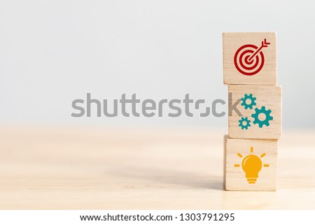 Concept of business strategy and action plan. Wood cube block stacking with icon