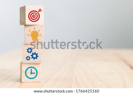 Concept of business strategy and action plan. Wood cube block stacking with icon