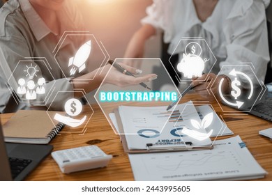 ฺBootstrapping concept, Business team analyzing income charts and graphs on office desk with bootstrapping icon on virtual screen. - Powered by Shutterstock