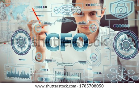 Concept business, technology, blockchain, internet and future network concept of computers. Young man works with neon hologram screen. On the screen of hologram inscription: cfo Chief financial office