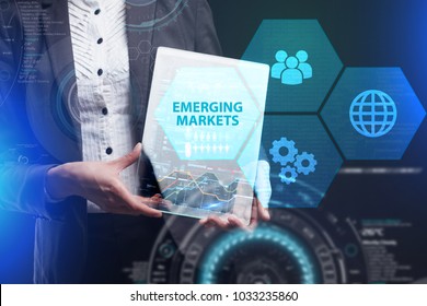 The concept of business, technology, the Internet and the network. A young entrepreneur working on a virtual screen of the future and sees the inscription: Emerging markets - Shutterstock ID 1033235860