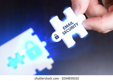 The concept of business, technology, the Internet and the network. A young businessman collects a puzzle with the proper inscription: Email security