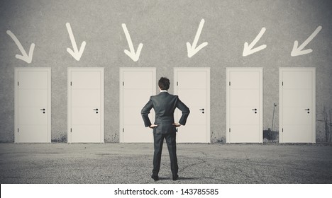 Concept of businessman choosing the right door - Shutterstock ID 143785585