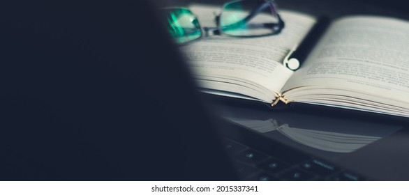 Concept of businessman or student working or using laptop, studying or learning book or reading textbook. Business success idea and education online training course at home