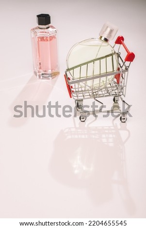 concept buying perfumes. shopping cart with perfume
