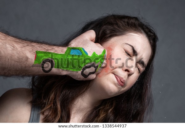 the concept of a car accident, an insured\
event . the fist represents the car at speed ,knocking the girl\
.the fist hits the woman in the face.close\
up.