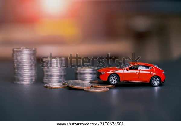 Concept car\
with coins, auto tax and financing, car insurance and car loans,\
concepts save money on car\
purchases.