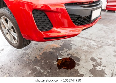 Concept Of Car Oil Leak Depicted With Red Vehicle And Puddle Of Oil Underneath