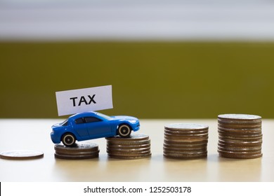 Concept Of Car Tax,car And Coins Chart On Wood Background.