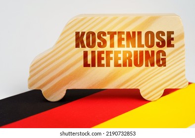 The concept of cargo transportation and logistics. On the flag of Germany there is a truck with the inscription - Free delivery. Text in German