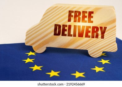 The concept of cargo transportation and logistics. On the flag of the European Union stands a truck with the inscription - Free delivery