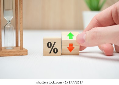 The concept of changing interest rates in banks falling and rising abstractly on wooden blocks. Close up. - Shutterstock ID 1717772617