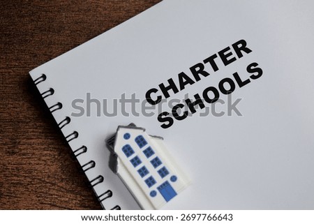 Concept of charter schools write on book isolated on Wooden Table.