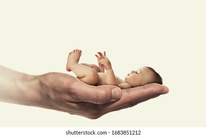 Concept of child care. Baby in mother palm on white isolated background.