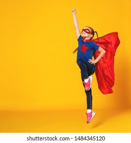 the concept of child superhero costume on yellow background