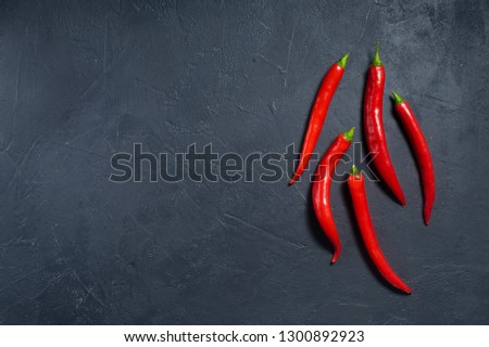 Concept: chili pepper. Dark background, top view, space for text
