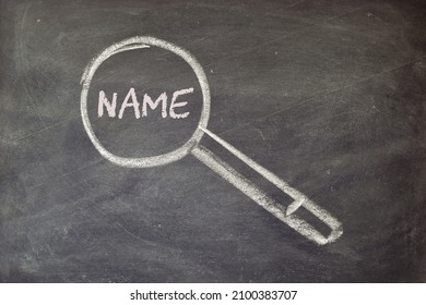 Concept of choosing a baby's name. Blackboard background with hand drawn magnifying glass. 
