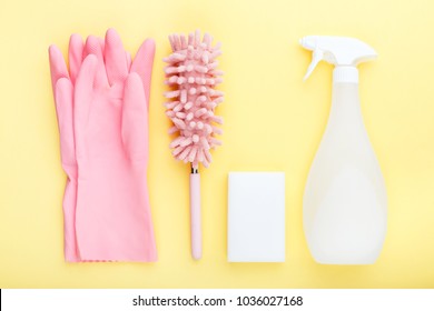 concept cleaning, on a yellow background pink gloves c soft dust brush, melamine sponge and spray for glasses - Powered by Shutterstock