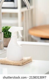 Concept Of Cleaning Product Spray Bottle And Rag In Modern Kitchen Beside Sink To Wipe The Counter Table Surface.