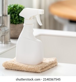 Concept Of Cleaning Product Spray Bottle And Rag In Modern Kitchen Beside Sink To Wipe The Counter Table Surface.