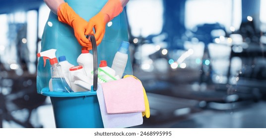 Concept of cleaning services in gyms. Cleaning lady in front of the gym. - Powered by Shutterstock