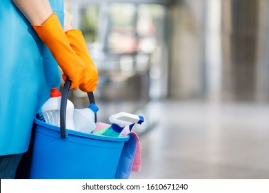 Concept cleaning services. The cleaning lady with a bucket and cleaning products .