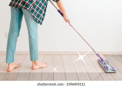 The concept of cleaning. Woman in casual clothes washing floors. There is a white wall in the background. There's a clean cleaning trail on the floor. Copy space