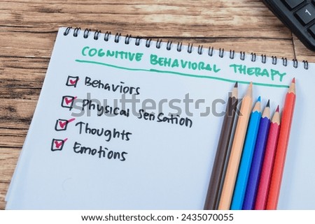 Concept of Cognitive Behavioral Therapy write on book with keywords isolated on Wooden Table.