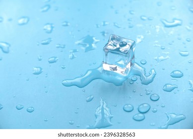Concept of cold and refreshing. Ice cubes with water drops on a blue background.
